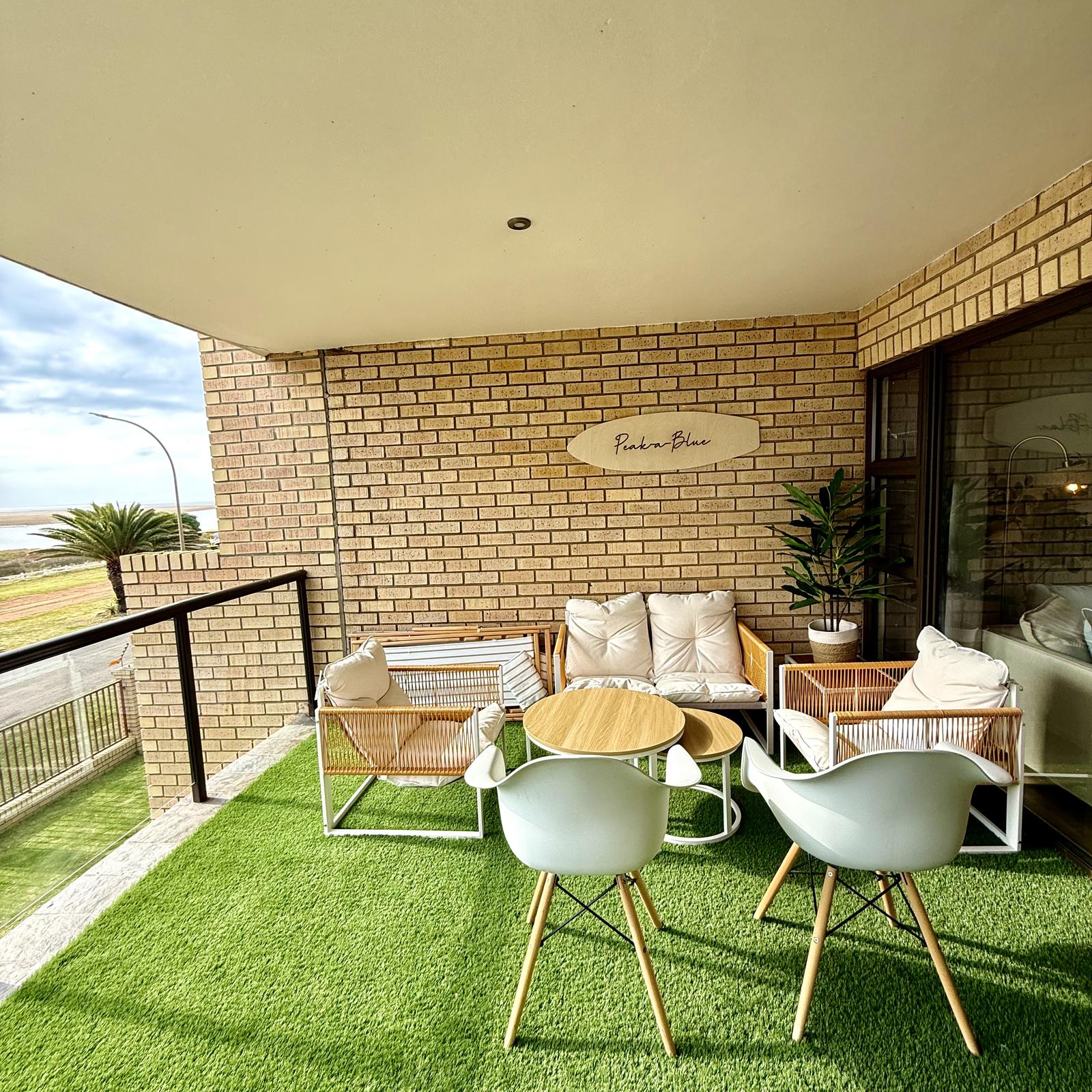 Peak-a-Blue balcony with Peak-a-Blue surfboard sign and lagoon view