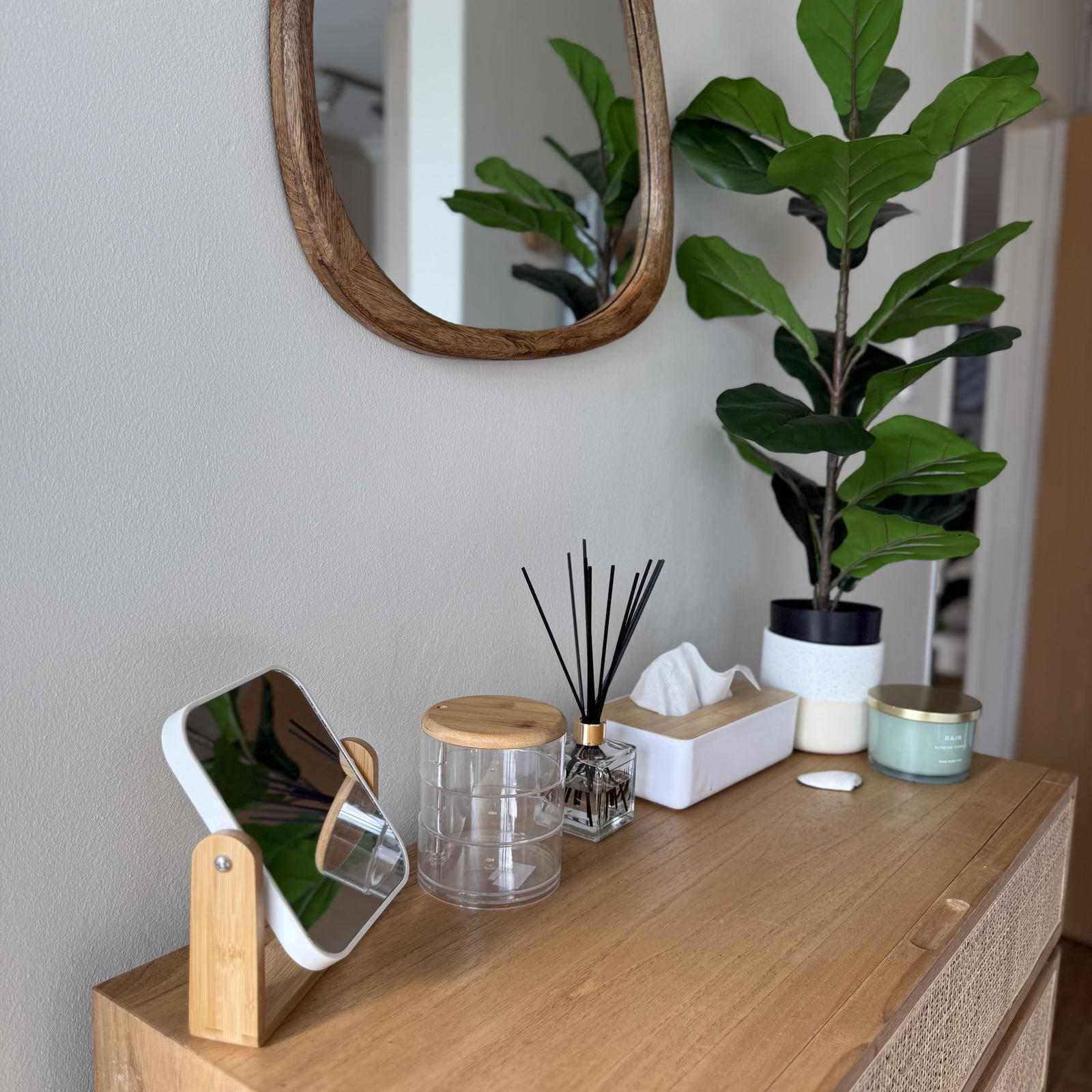 Peak-a-Blue bedroom vanity with reed diffuser and organic mirror